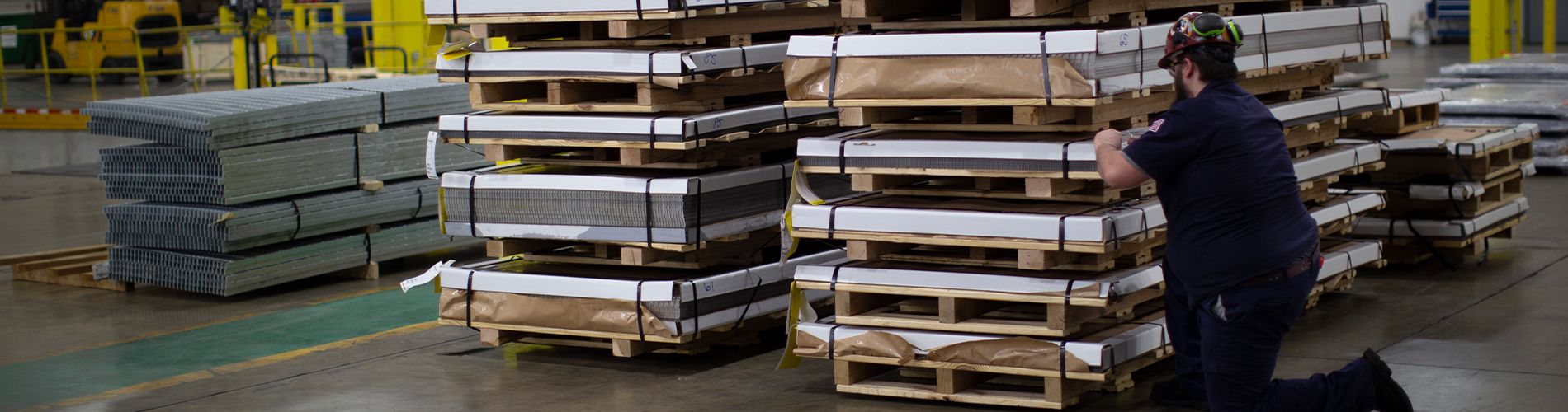 A photo of a McNICHOLS associate checking on a stack of orders that are ready to be shipped.