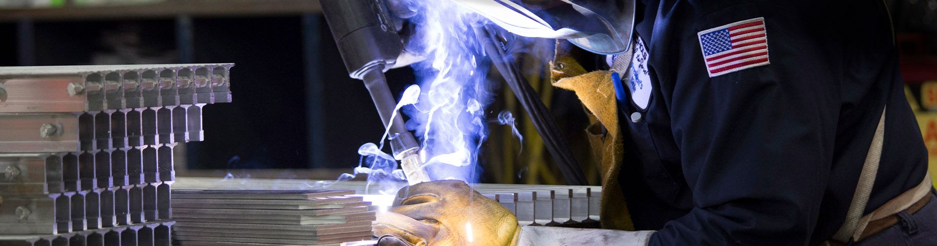 A McNICHOLS operations associate welding a piece of bar grating.