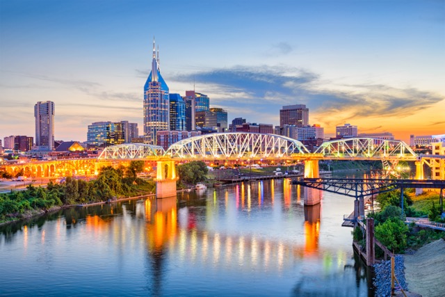 Image of Nashville, Tennessee's downtown skyline on the Cumberland River during sunset.