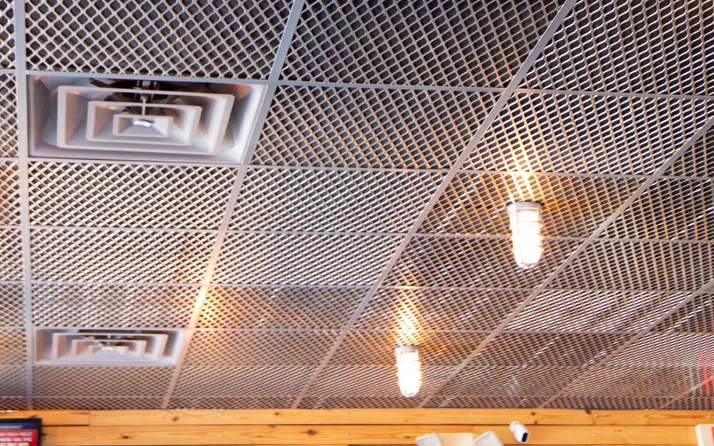 A photo of a shop's ceiling tiles that are made out of expanded metal.