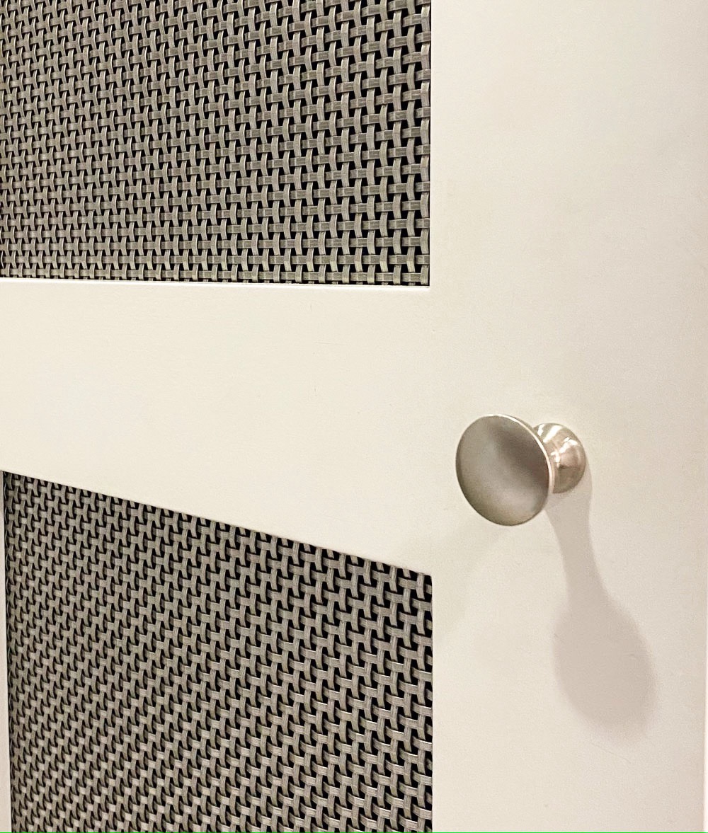 A close-up photo of Designer Wire Mesh ASHLAND™ 2015 used as a cabinet insert.