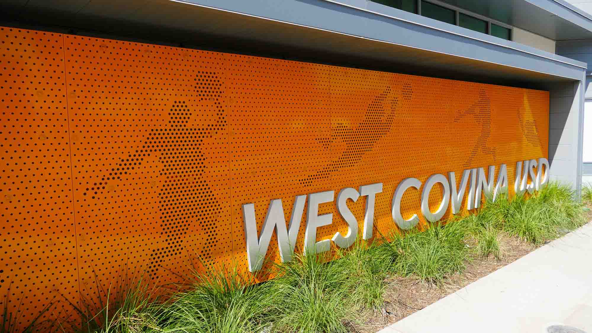 A picture of a custom orange Perforated Metal art piece at Edgewood High School in West Covina, California.