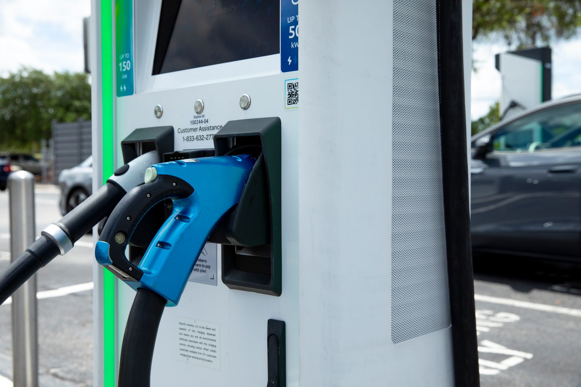 A closeup image of a charging station's connector for an electric vehicle, focused on a piece of Perforated Metal used as an insert for filtration.