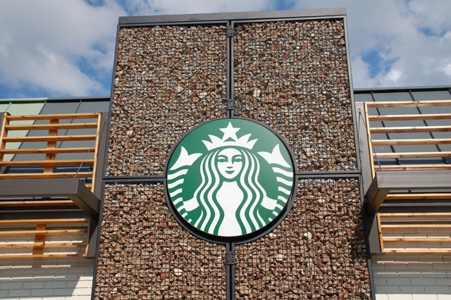 A Starbucks sign on top of an ECO-MESH® Gabion Wall, filled with rocks.