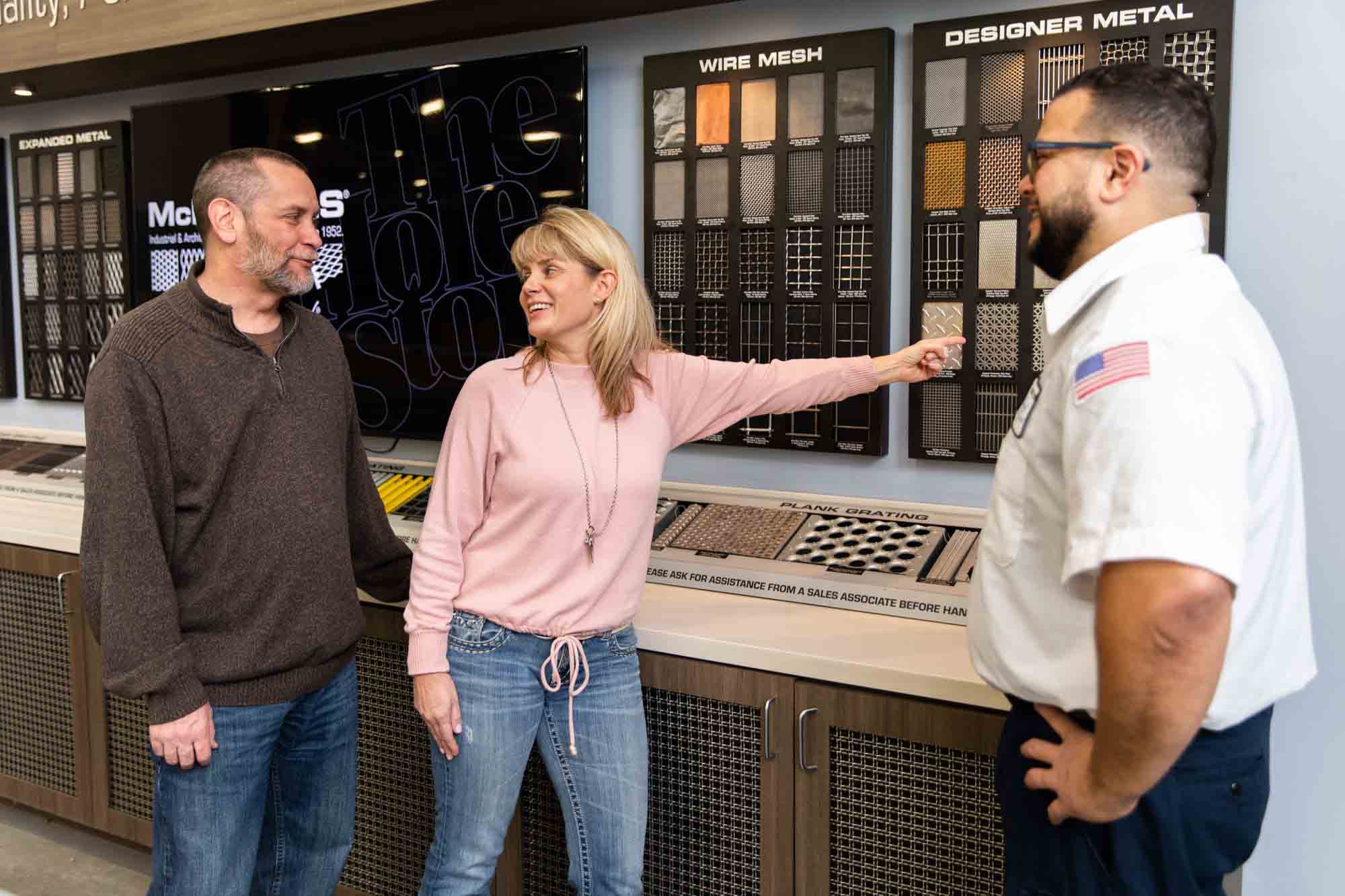 Picture of associates browsing product samples with a customer in the showroom.