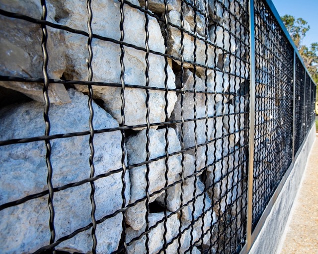 Intercrimp Wire Mesh used as a part of a gabion wall system filled with rocks.