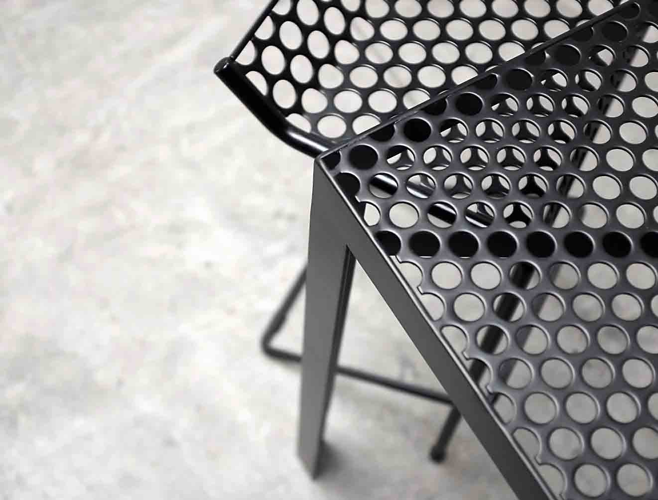 A close-up photo of a chair made out of Perforated Metal.