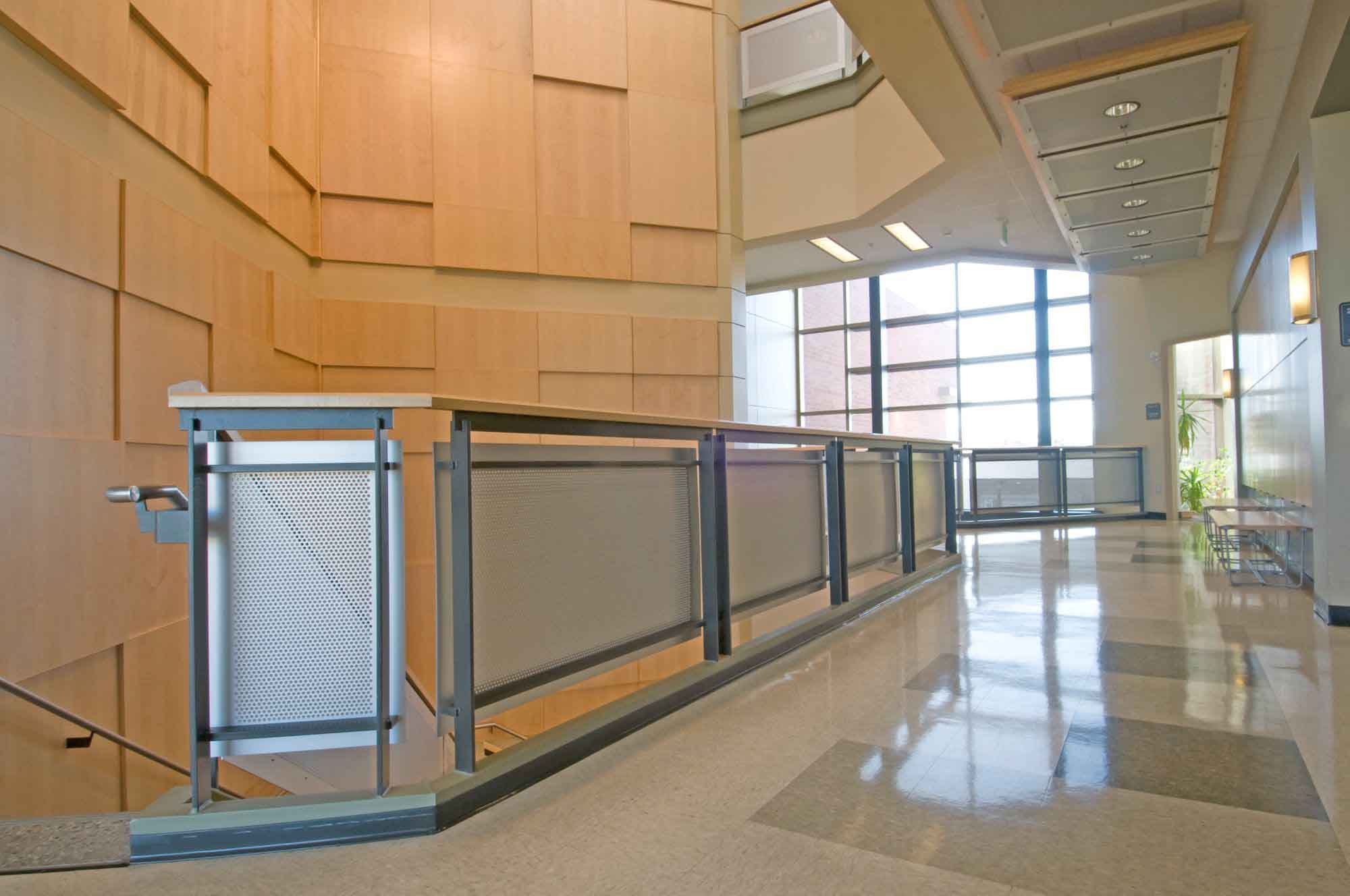 A picture of balcony and staircase railings that have Perforated Metal Infill Panels inside The Science and Mathematics Building at Spokane Community College.