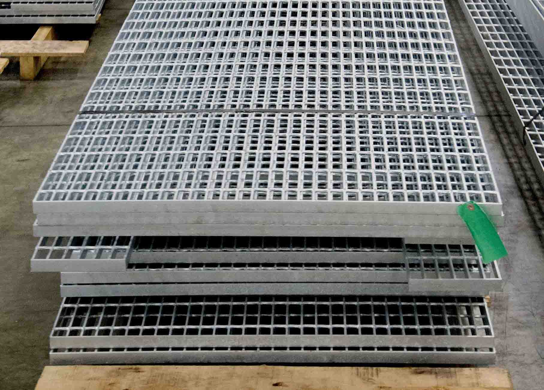 A stack of banded Bar Grating panels that are sitting on top of a wooden skid.