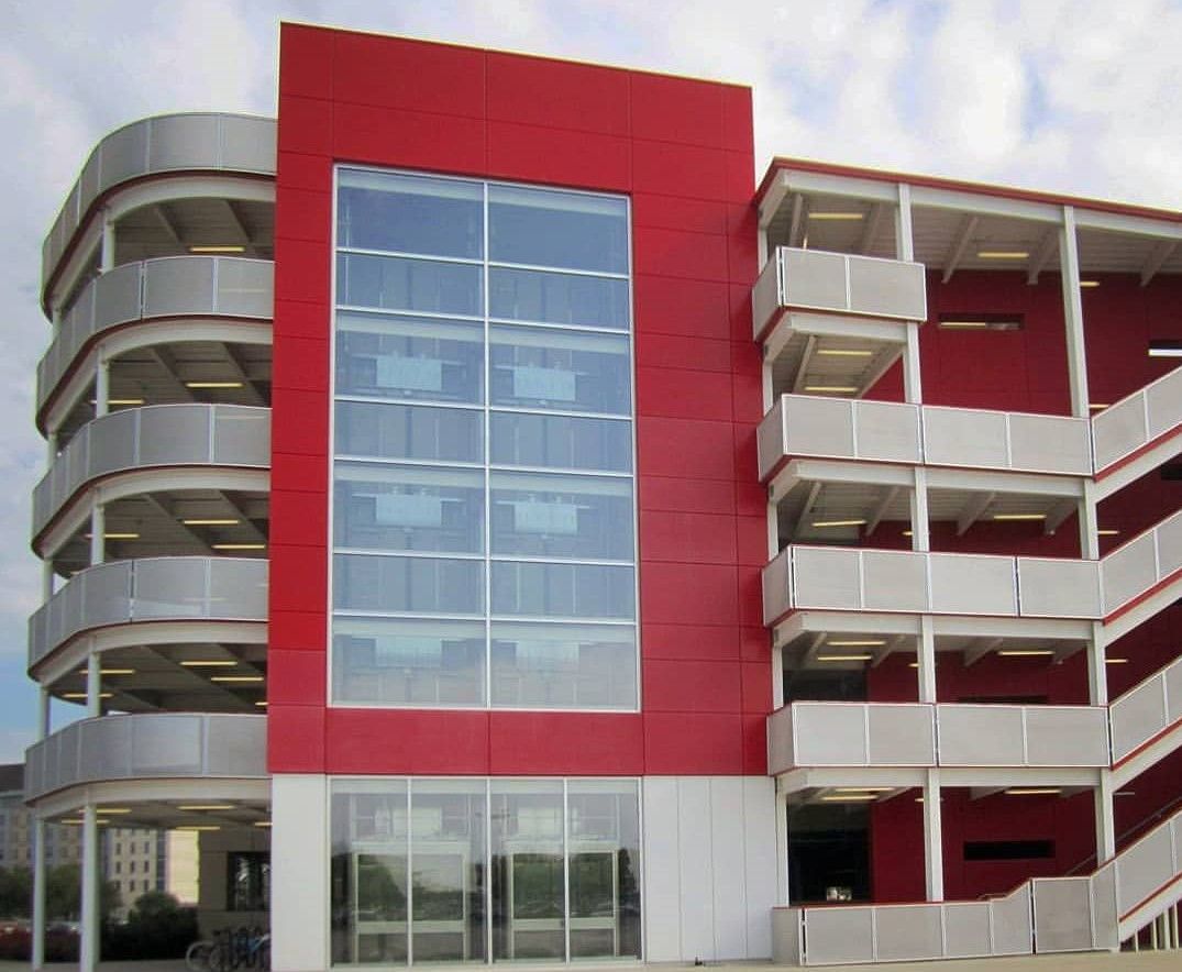 Perforated Metal used to create Infill Panels for railings in a parking garage at the University of Houston.