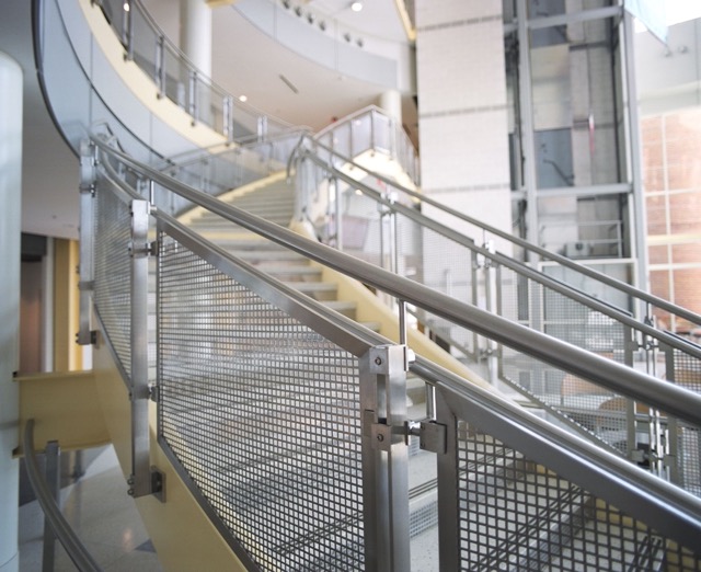 Square Hole Perforated Metal Infill Panels used as staircase railings inside a building at the University of Maryland.