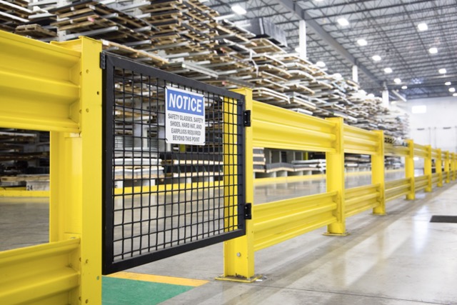 A gate with a Wire Mesh Infill Panel that leads onto the floor of a McNICHOLS® Metals Service Center.