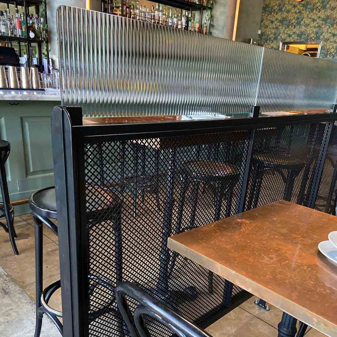 Perforated Metal used as the tops of tables at the Creek Eatery.