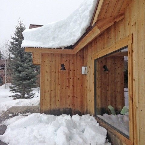 Snow piled up on a roof and deck in Wyoming.