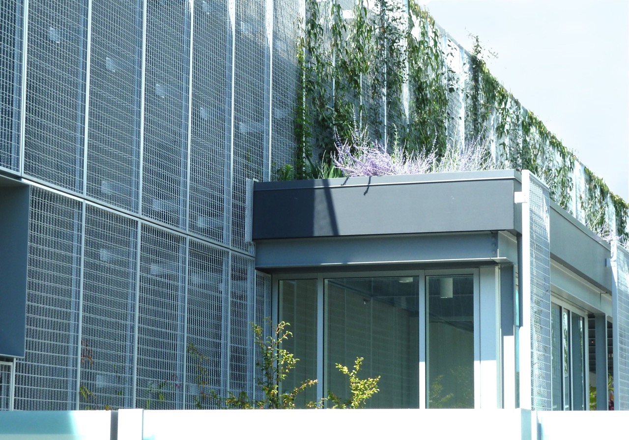 A side view of the front entrance alongside several panels of ECO-MESH®.