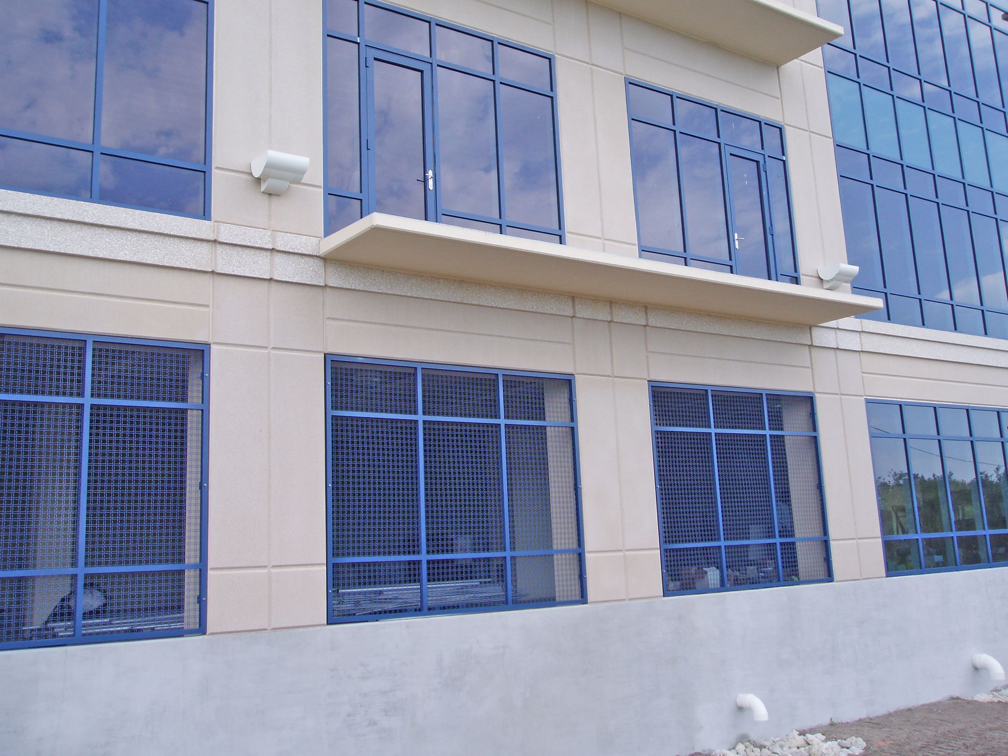 Another view of multiple of the garage, protected by security screens made out of Designer Mesh.