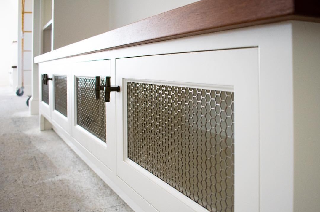 Hexagonal Hole Perforated Metal infill panels used as cabinet inserts for an entertainment center.