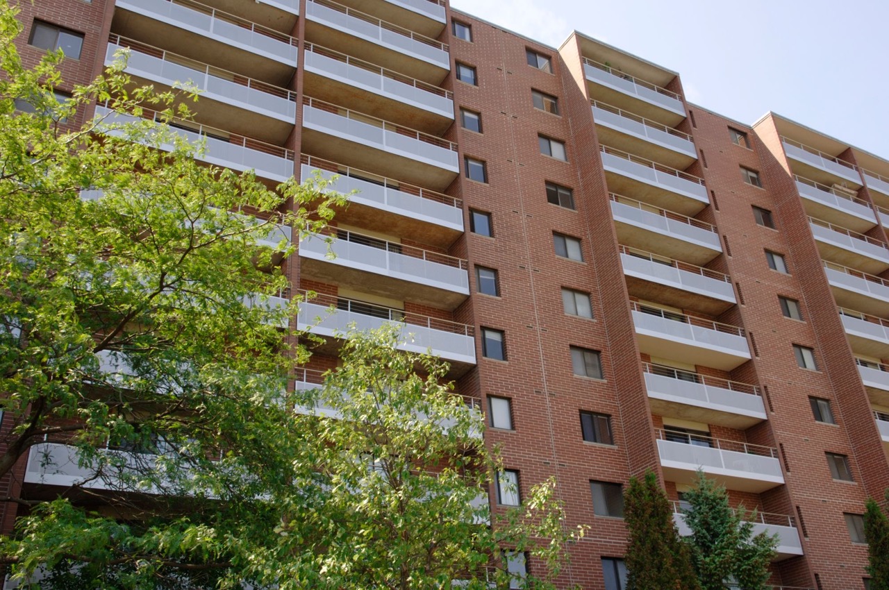 A brick apartment from the 1970's with Perforated Metal panels on the balconies.