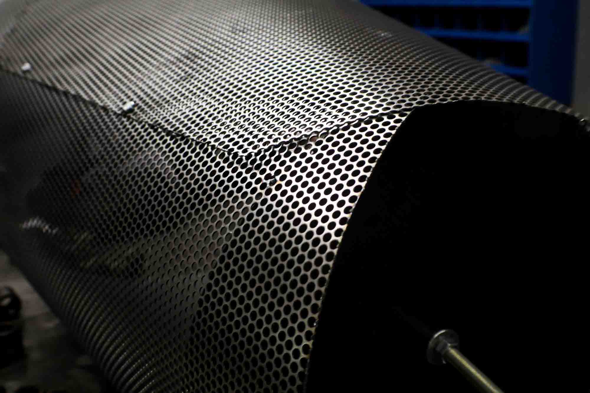 A sheet of Round Hole Perforated Metal that had been molded and formed into a light fixture.