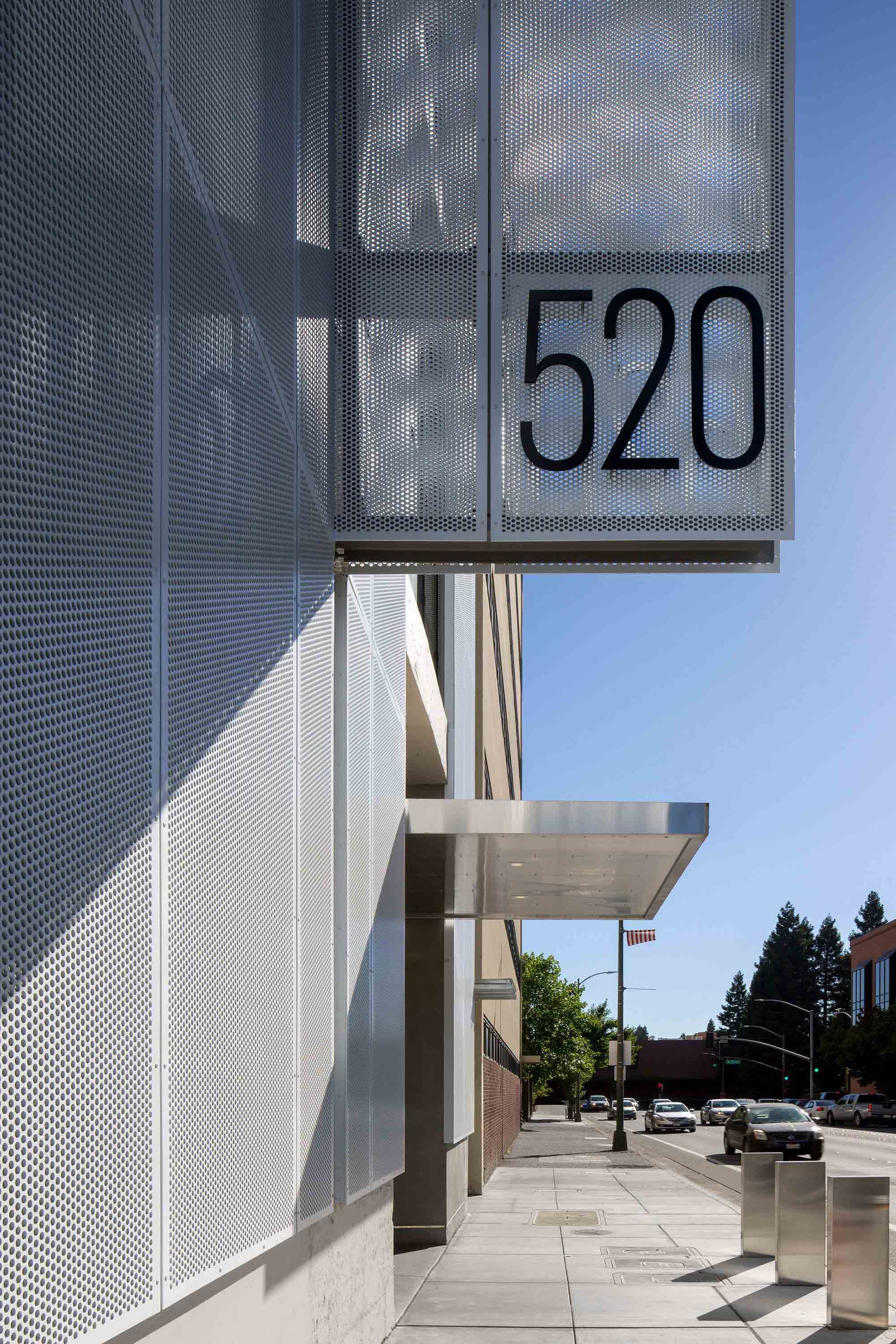 A '520' Perforated Metal sign representing the address number for the building.