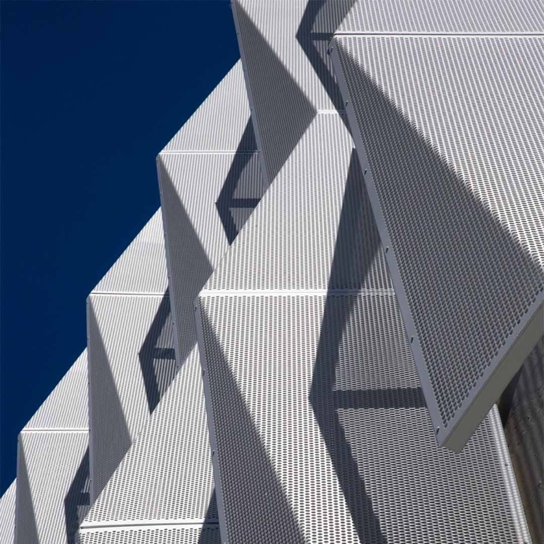 A picture of the Perforated Metal panels that function as a facade on the side of a building.