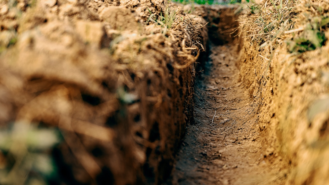 Long earthen trench dug for a Trench Grate or Drain System.