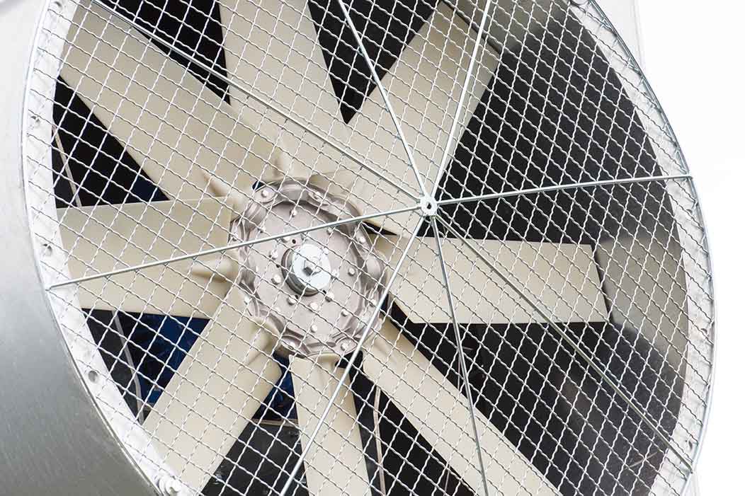 A closeup view of a ventilation fan that is part of a big grain dryer.
