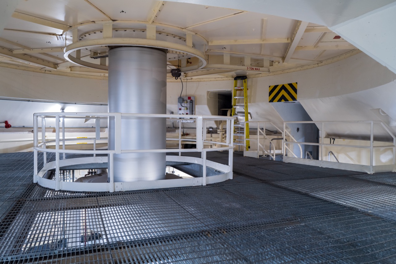 The Shaft of a Hydroelectric Generator surrounded by Bar Grating flooring.