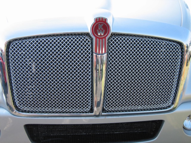An image of the front of a semi-truck, focused on the grille that is made out of Wire Mesh for filtration.