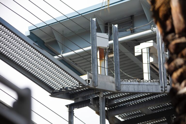 Angled platform connection detail with 5-Diamond GRIP STRUT® Plank Grating integrated into industrial support structure.