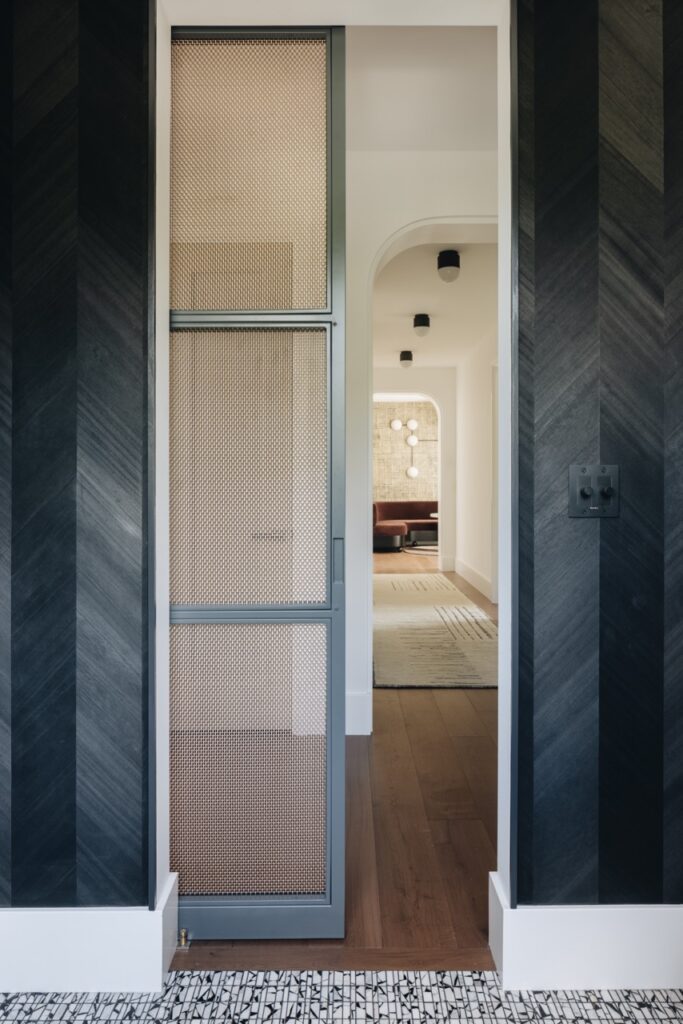 Designer Mesh SHIRE™ 8148 sliding door panel in a hallway opening, designed by Amy Storm & Co.