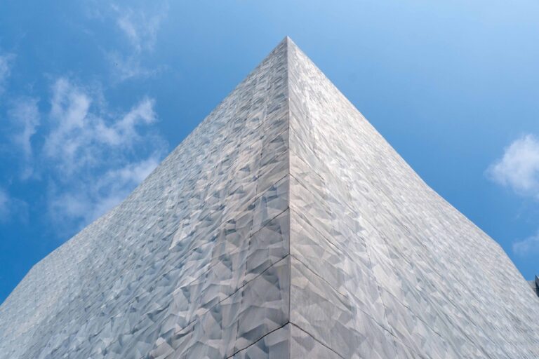 Angular exterior facade clad with Designer Expanded Metal, Flattened LANCET™ 31651-F at Walker Art Center in Minneapolis, MN, showcasing a faceted, light-reflective surface against the sky.