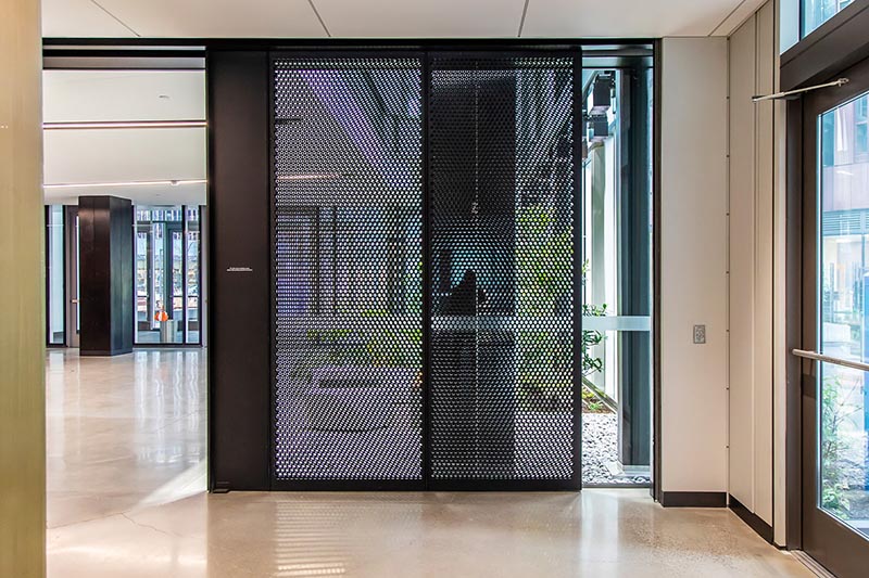 A Round Hole Perforated Metal partition in an Amazon office space.