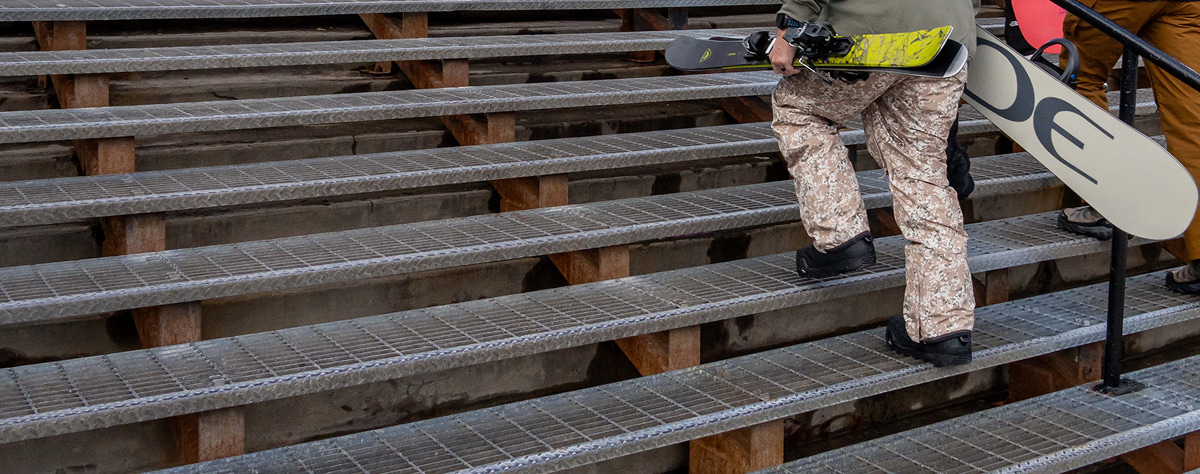 Bar Grating Stair Treads used for outdoor steps at a ski resort with people walking up carrying snowboards.