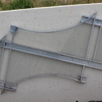 Angled view of Square Wire Mesh sheets with an Intercrimp Weave and framed with U-Edging, mounted on a concrete wall in a Cleveland pedestrian tunnel.