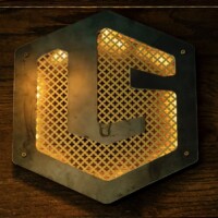 Backlit metal logo sign featuring Designer Perforated, CLOVERLEAF 2051, mounted on a dark wood surface.