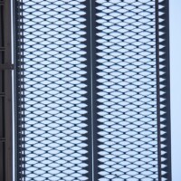 Elevated walkway panels featuring 5-Diamond GRIP STRUT® Plank Grating with diamond-shaped openings against the sky.