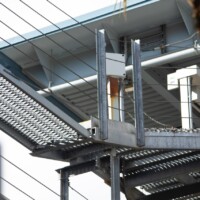 Angled platform connection detail with 5-Diamond GRIP STRUT® Plank Grating integrated into industrial support structure.