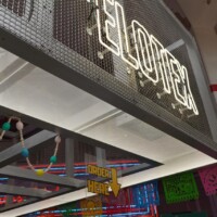 Neon sign mounted on Square Wire Mesh sheet that is Welded and Stainless Steel above a vendor stall at POST Market Houston.