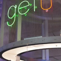 Square Wire Mesh sheet that is Welded and Stainless Steel with neon signage in a curved interior installation at POST Market Houston.