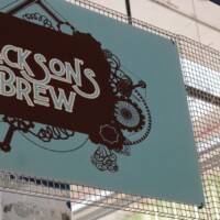 Sign reading “Jackson’s Brew” mounted on a Square Wire Mesh sheet that is Welded and Stainless Steel in Post Market, Houston, TX.