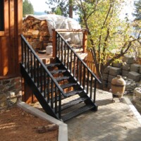 View of 5-Hole PERF-O GRIP® Plank Grating stair treads leading up to a porch.