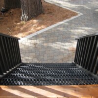 Residential stair system featuring 5-Hole PERF-O GRIP® Plank Grating stair treads, powder-coated black.