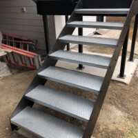 Residential stair system featuring TRACTION TREAD™ Plank Grating stair treads.