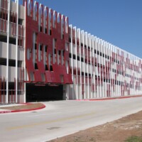 Red Molded Fiberglass Grating sunshades on a parking garage.
