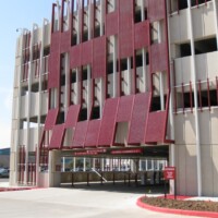 Red Molded Fiberglass Grating sunshades on a parking garage.