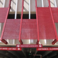 Red Molded Fiberglass Grating sunshades on a parking garage.