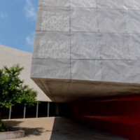Exterior architectural facade clad with Designer Expanded Metal, Flattened LANCET™ 31651-F at Walker Art Center in Minneapolis, MN, creating a textured, light-filtering surface above an entry walkway.