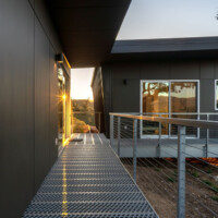 Side walkway view of residence with 6-Hole PERF-O GRIP® Plank Grating flooring and metal railing system.