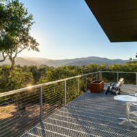 Elevated deck overlooking landscape with 6-Hole PERF-O GRIP® Plank Grating flooring and cable railings.